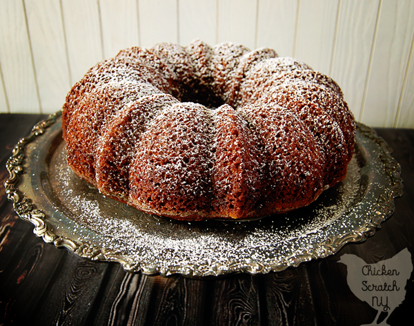pumpkin gingerbread baked with beer dusted with powdered sugar on a silver metal cake stand