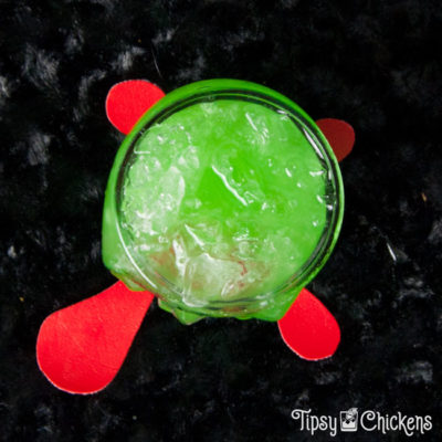 Crushed Ice In Cocktail Glass On Blue Surface. Beverage Concept