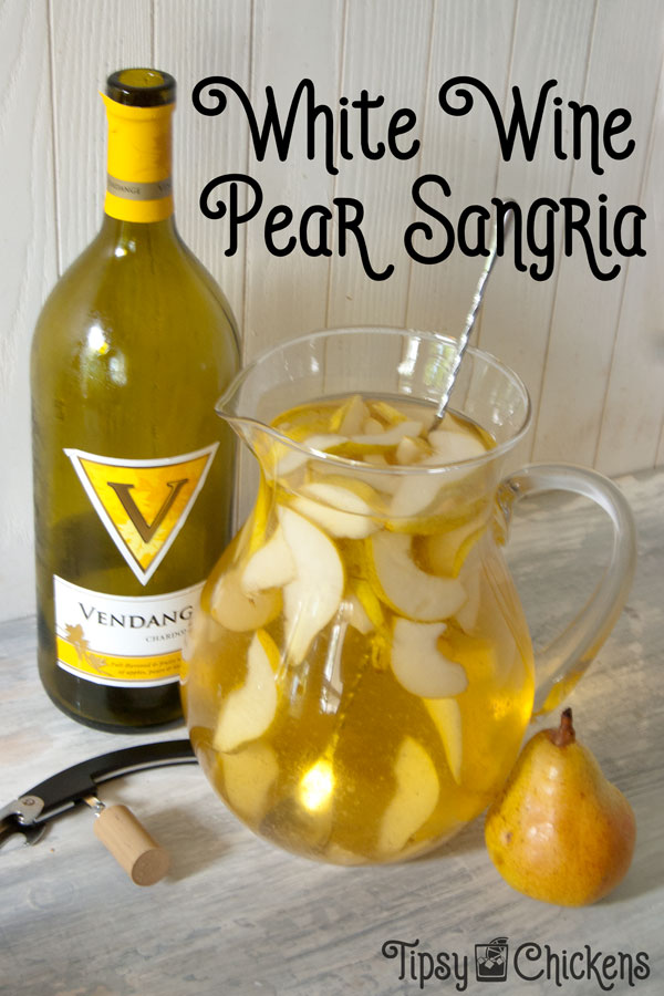 glass pitcher filled with sliced pears and white wine pear sangria with a bottle of chardonnay, a pear and a wine bottle opener