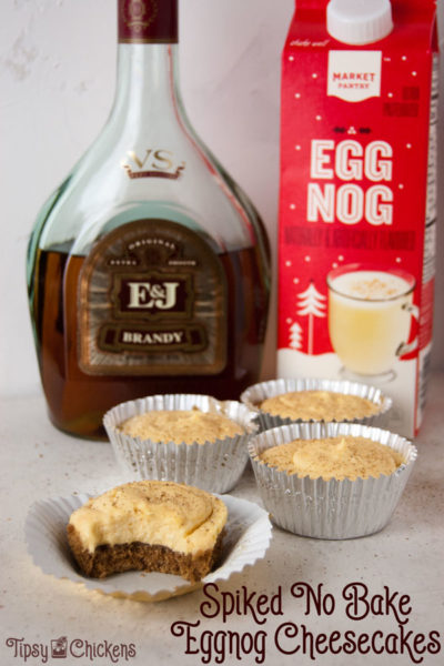 bottle of brandy, carton of eggnog and four mini no bake eggnog cheesecakes spiked with brandy and sprinkled with nutmeg