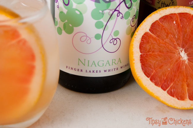 niagara white wine with a white eine spriter and half a pink grapefruit