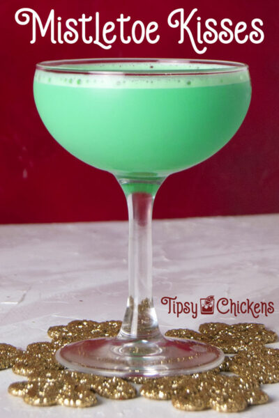 mint and Irish cream Christmas cocktail in a coupe glass on a golden snowflake 