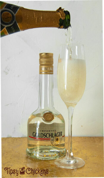 pouring champagne into a champagne flute filled with triple sec, goldschlager and gold flake