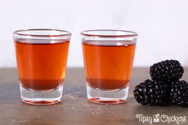 strained american honey blackberry whiskey in two shot glasses