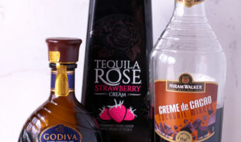 chocolate liqueurs layered with tequila rose in two shot glasses to show how different densities layer