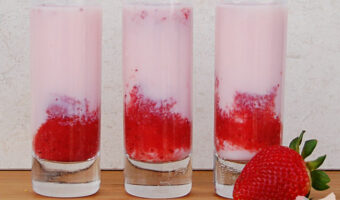 three shooter glasses filled with strawberrry short cake shots