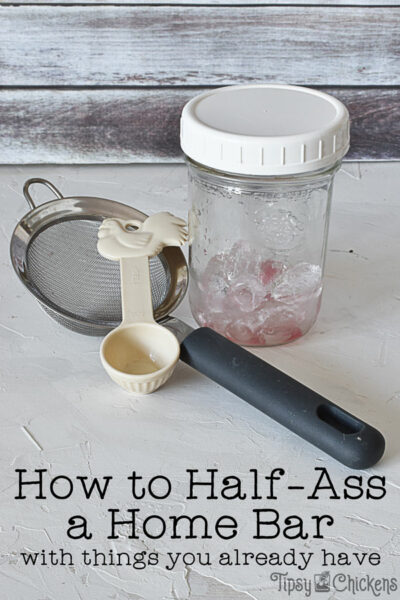 mason  jar cocktail shaker, table spoon and mesh spoon used to make cocktails at home if you don't have any bar tools