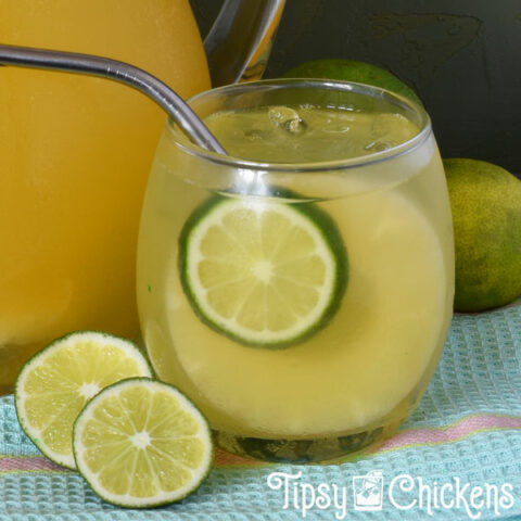 rounded clear drinking glass filled with champagne punch