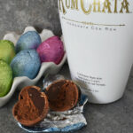 bottle of RumChata, hollow chocolate Easter eggs filled with chocolate RumChata ganache