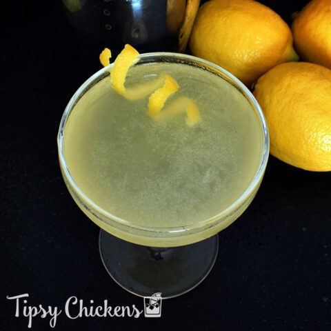 top view of lemon meadow cocktail in a coup glass with a lemon spiral garnish